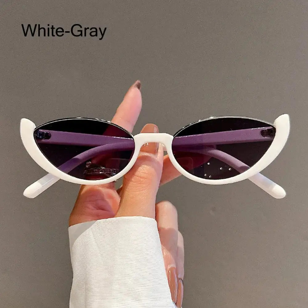 a person holding up a pair of sunglasses