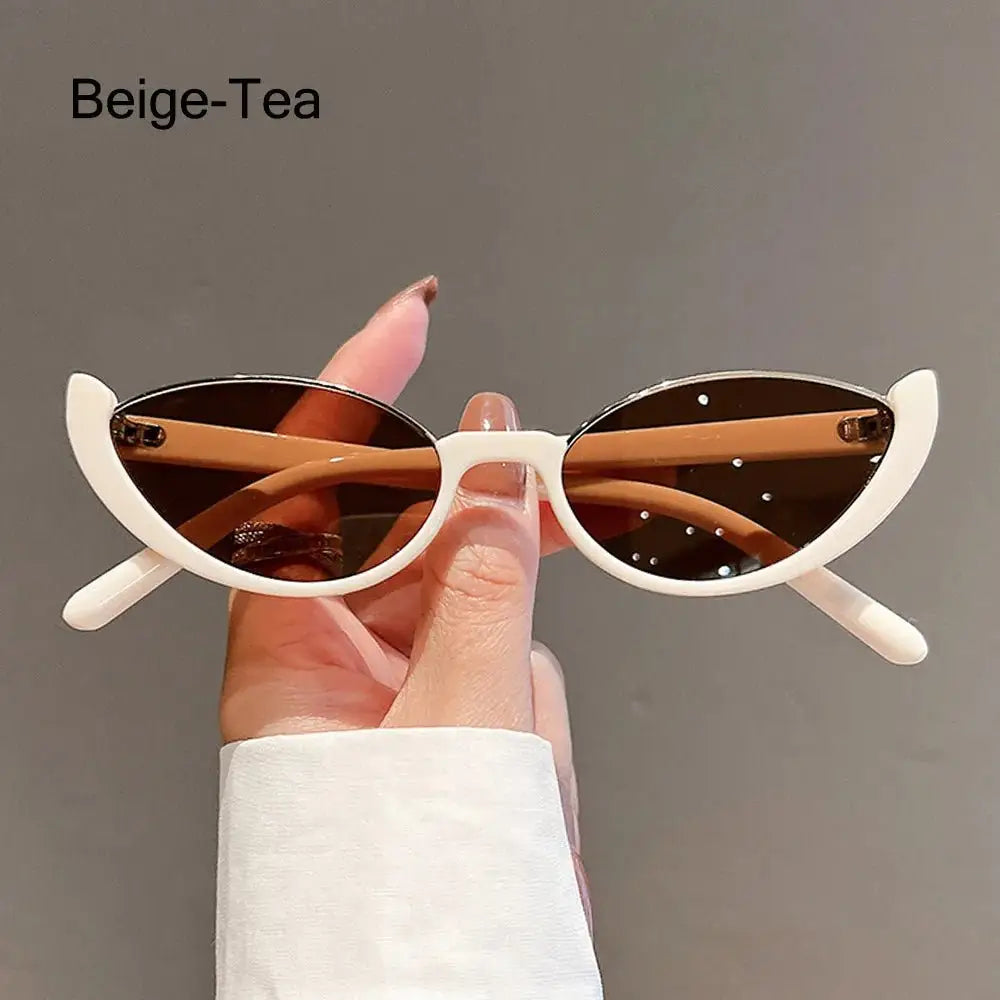 a person holding up a pair of sunglasses