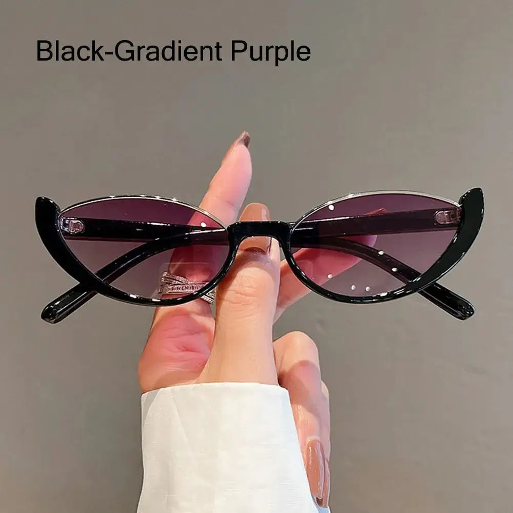 a person holding up a pair of black sunglasses