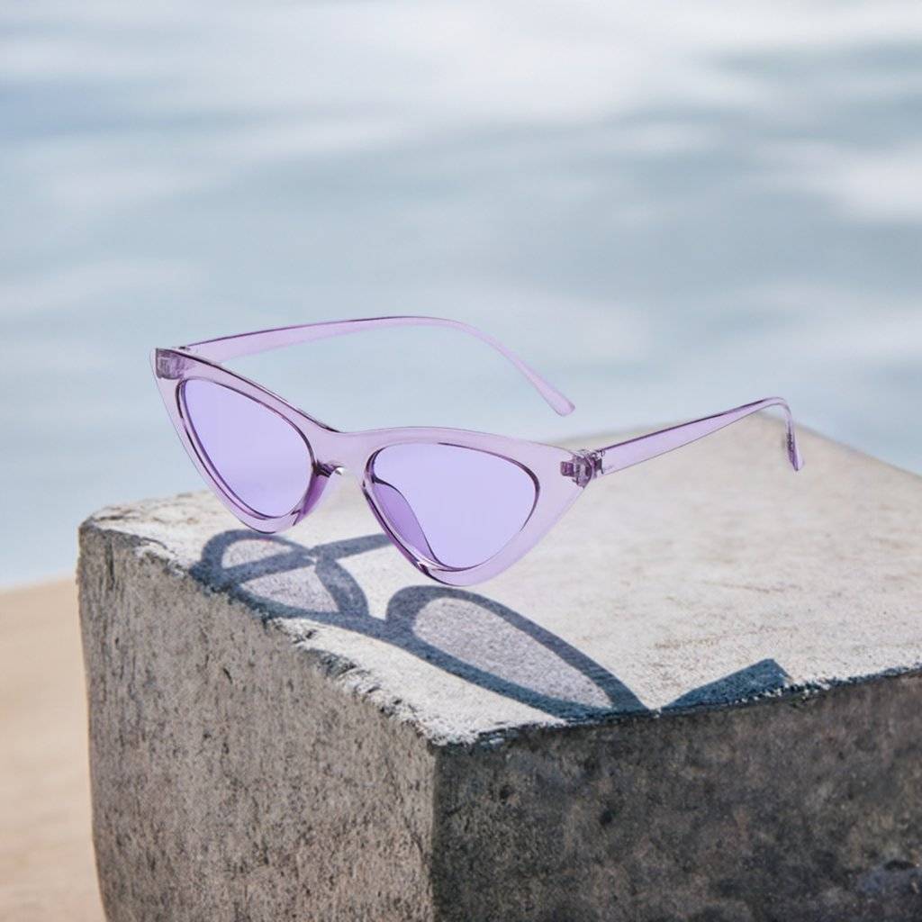 a pair of sunglasses sitting on top of a cement block