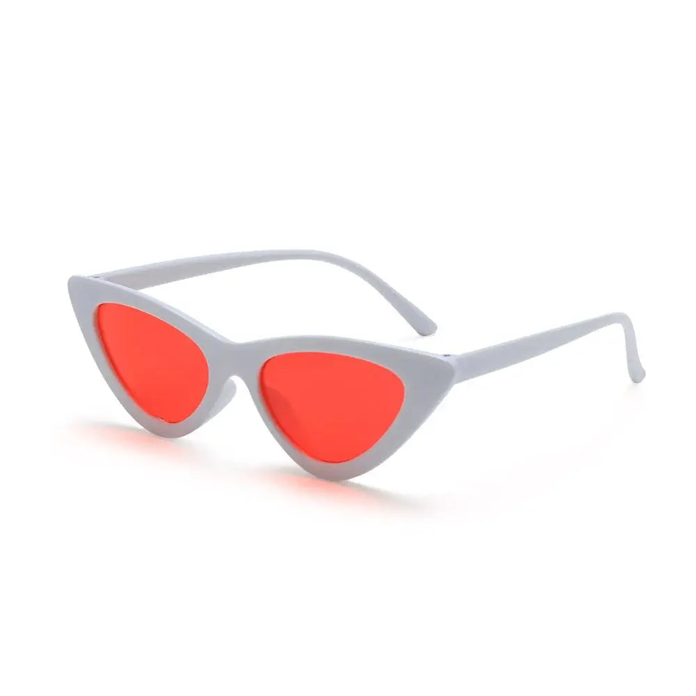 a pair of sunglasses with red lenses on a white background