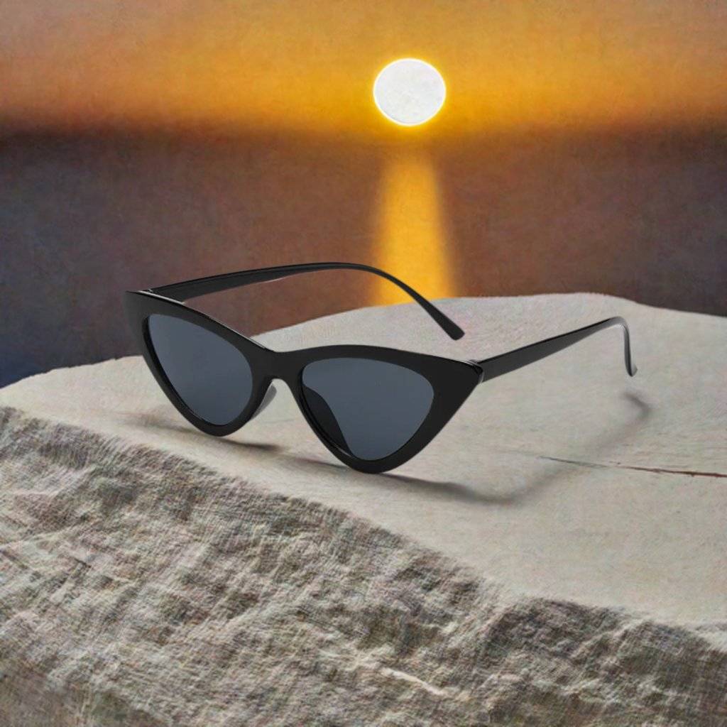 a pair of sunglasses sitting on top of a rock