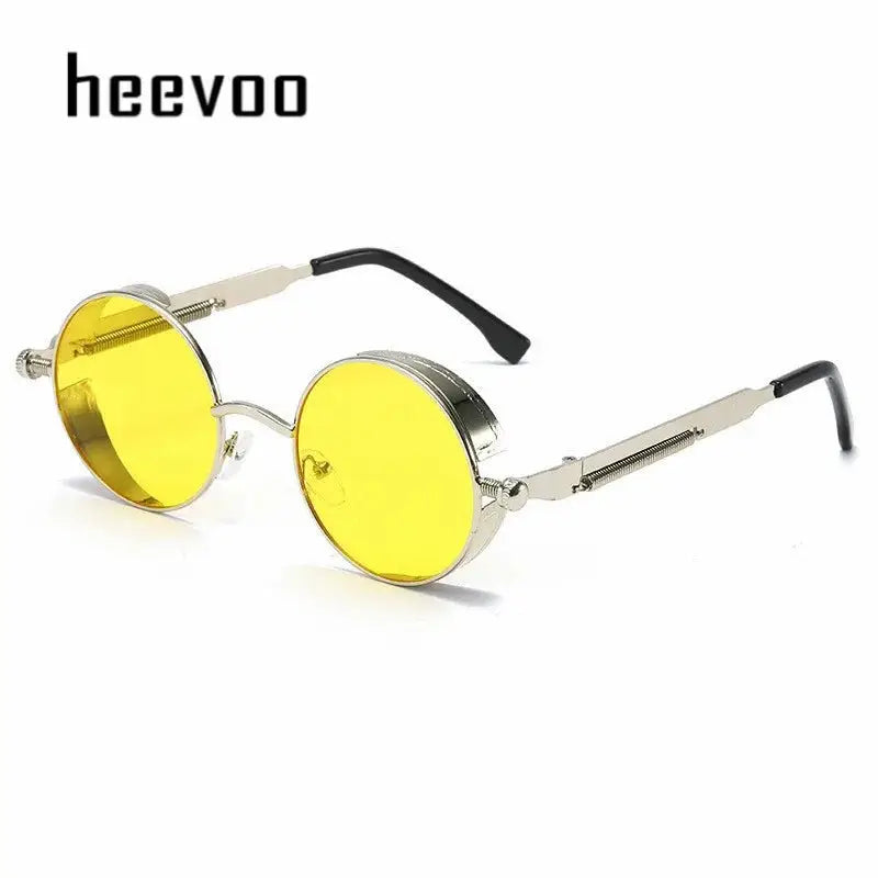 a pair of yellow sunglasses with a metal frame