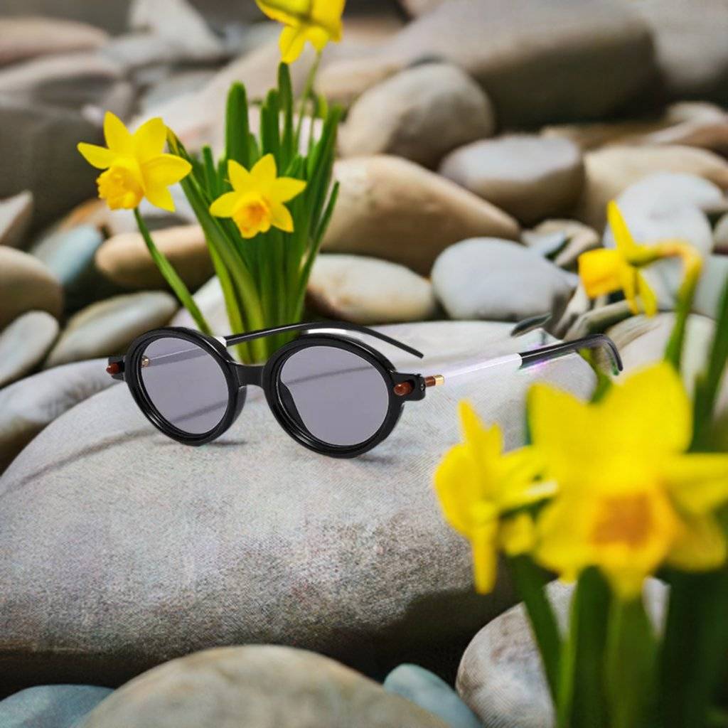 a pair of sunglasses sitting on top of a rock