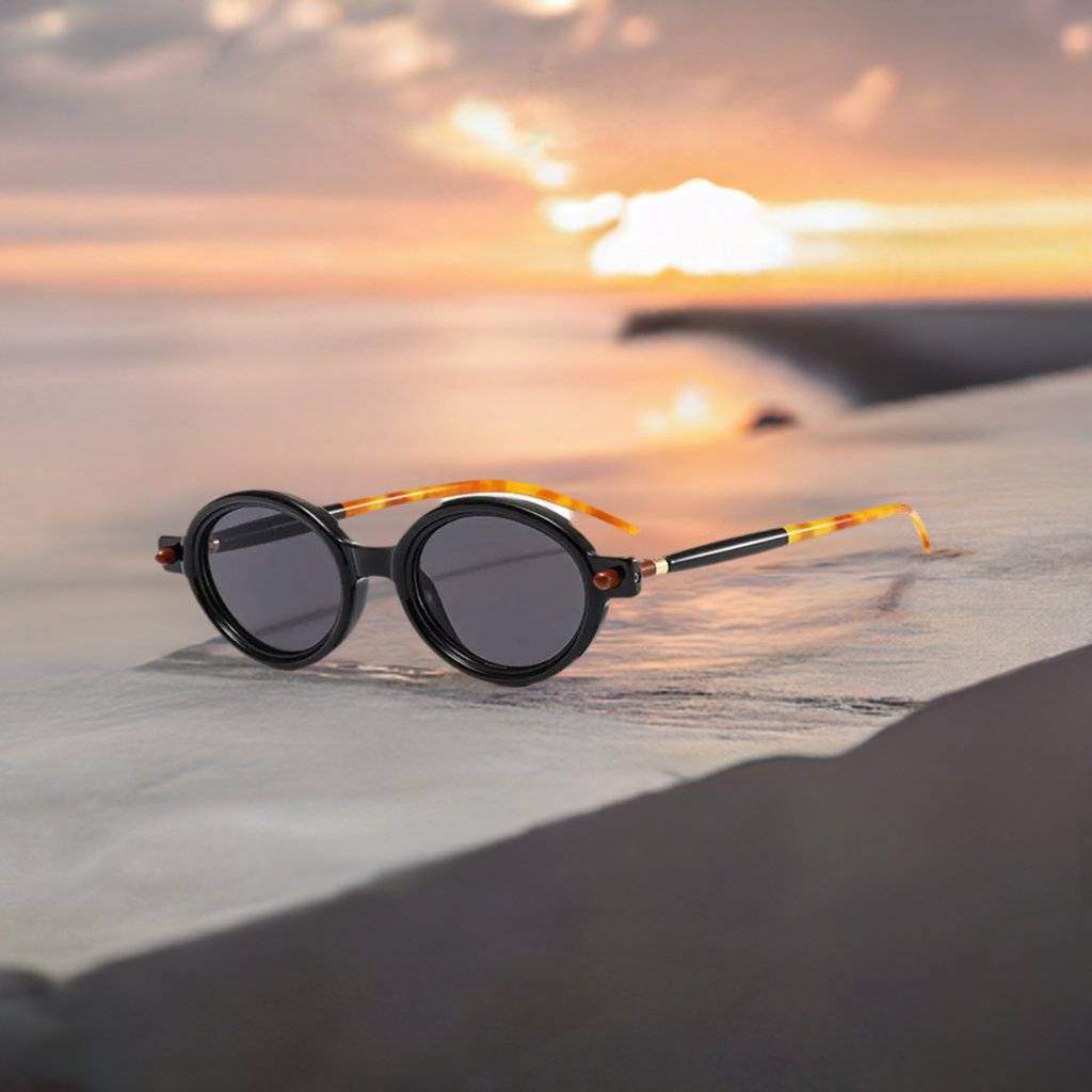 a pair of sunglasses sitting on top of a beach