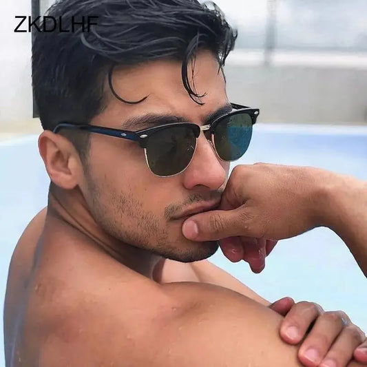 a shirtless man with sunglasses leaning on his arm