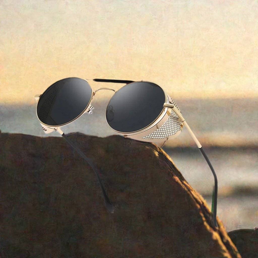 a pair of sunglasses sitting on top of a rock