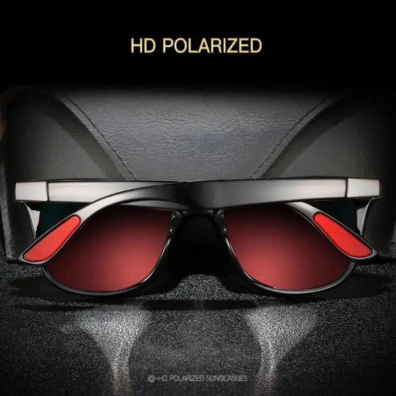 a pair of red glasses sitting on top of a black surface