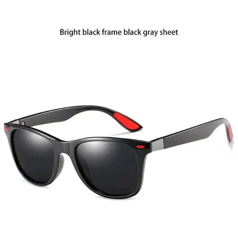 a pair of black sunglasses with red trim