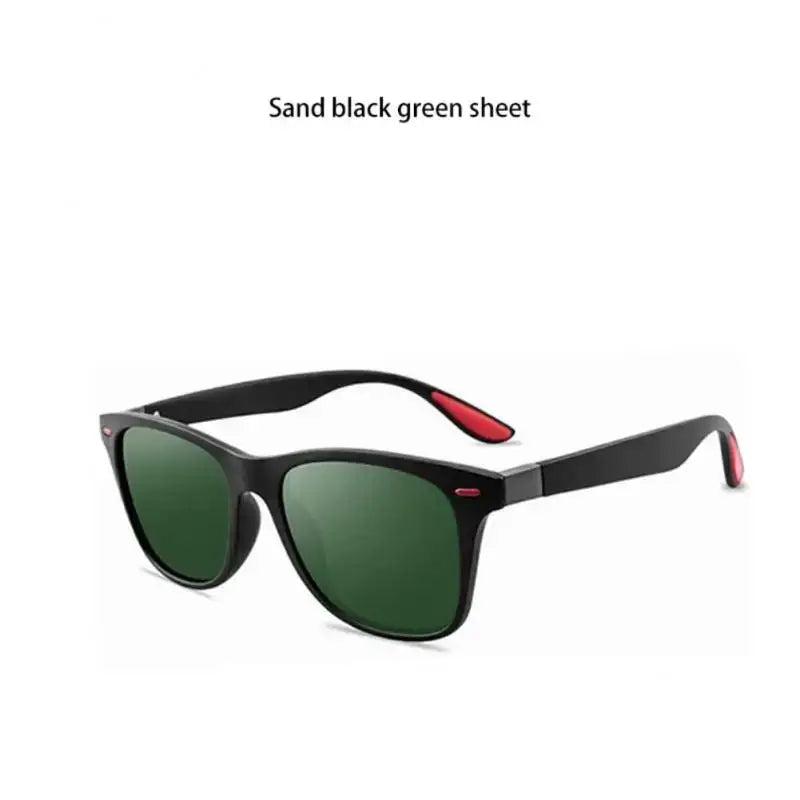 a pair of black sunglasses with green lenses